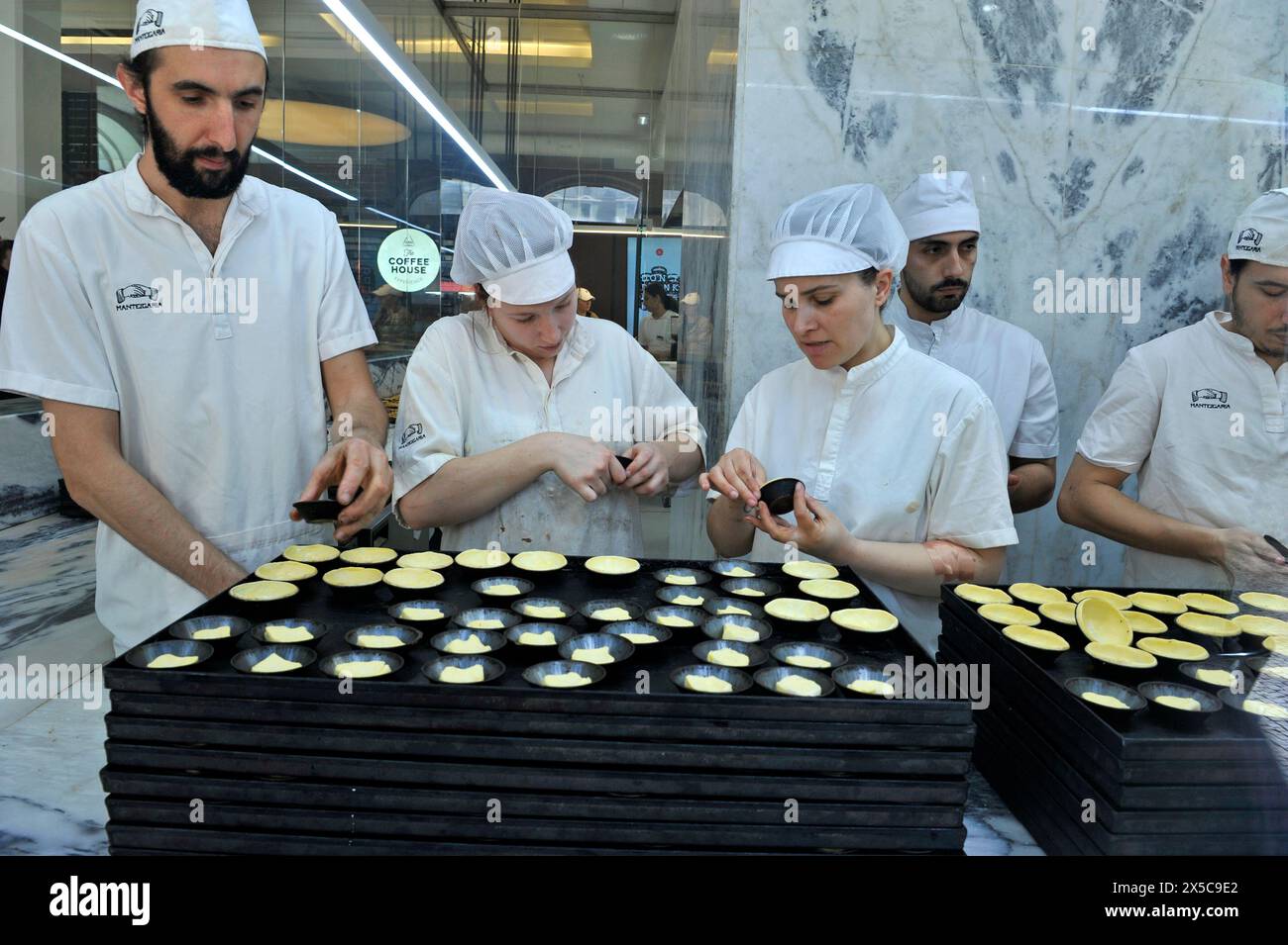 Chef che creano piccoli dessert nella vetrina della pasticceria, Porto, Portogallo, Europa Foto Stock
