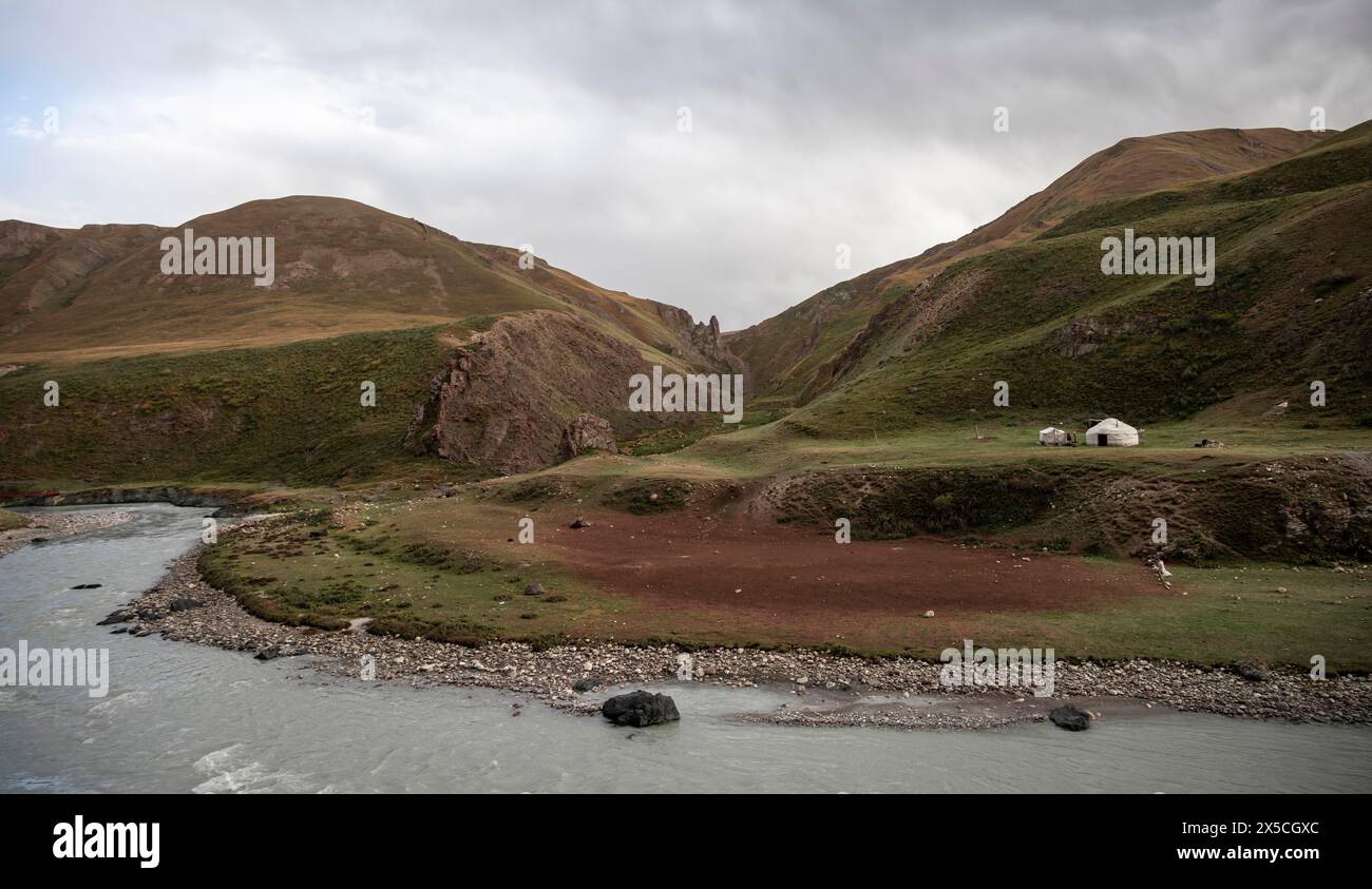 Yurta lungo un fiume, paesaggio montano desolato, Tian Shan, Sky Mountains, Sary Jaz Valley, Kirghizistan Foto Stock