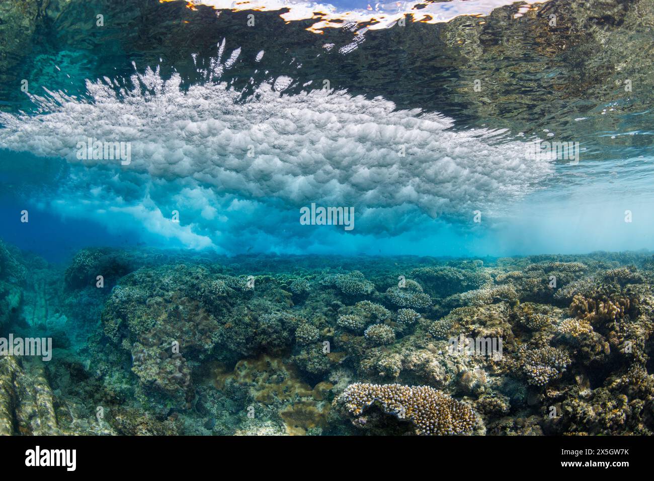 Il surf si schianta sulla barriera corallina al largo di Gun Beach sull'isola di Guam in Micronesia. Foto Stock