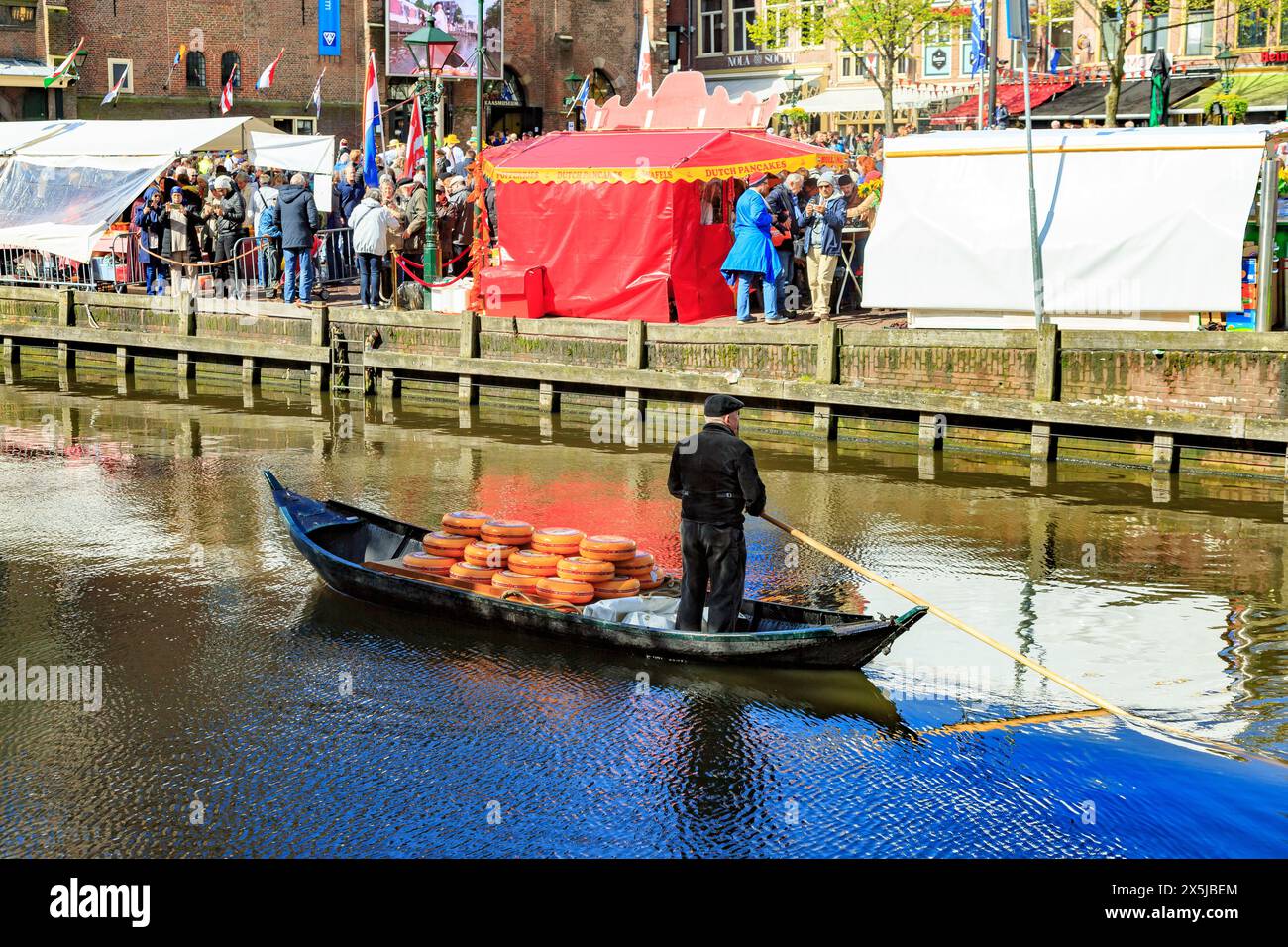 Paesi Bassi, Olanda settentrionale, Alkmaar. La tradizionale cittadina olandese con canale e il mercato del formaggio presso il Waagplein. Formaggio in barca a remi a mano. (Editoria Foto Stock