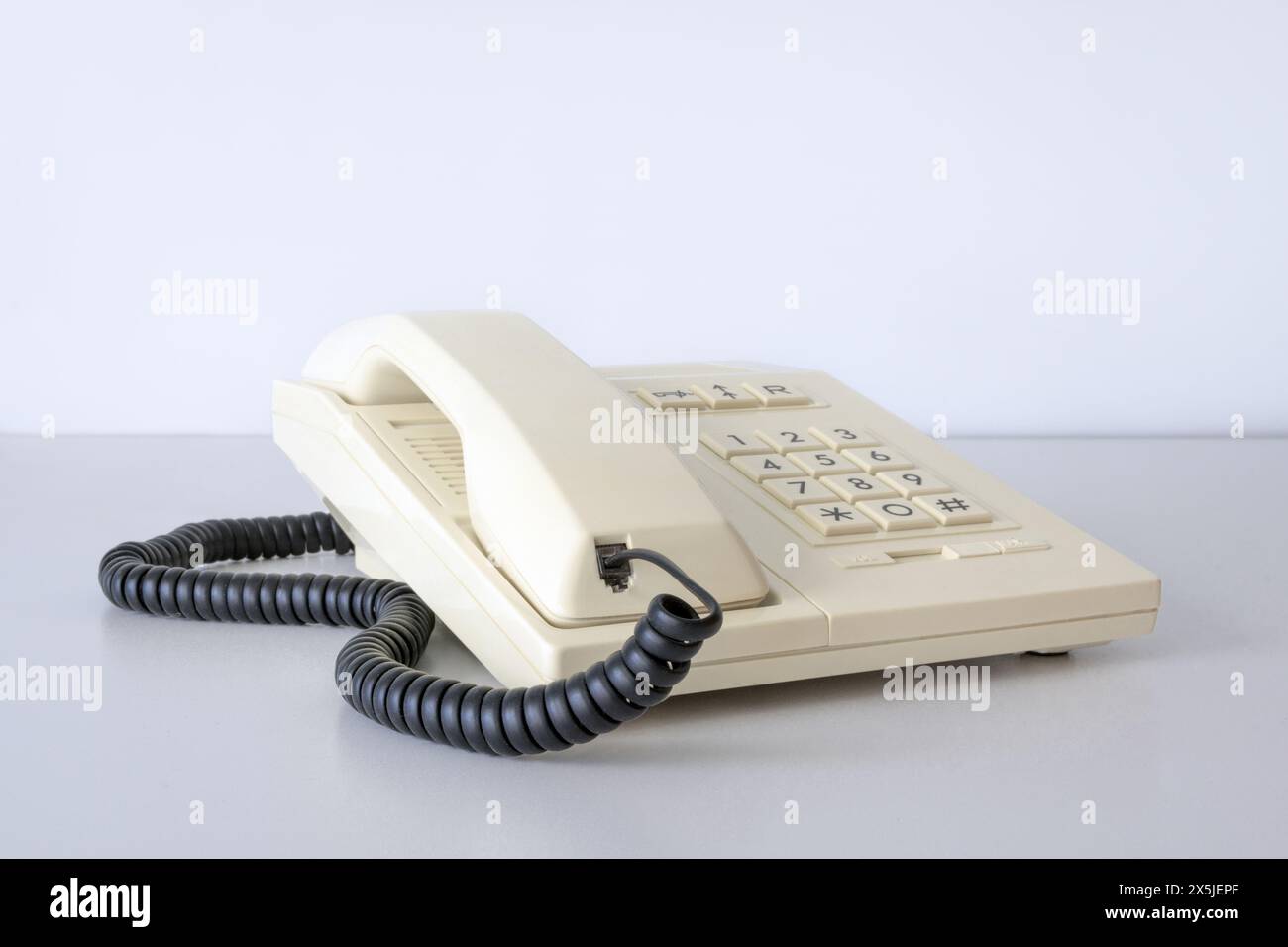 Telefono fisso anni '80, '90 Composizione tramite pulsante. Bianco. Isolato su un tavolo bianco Foto Stock