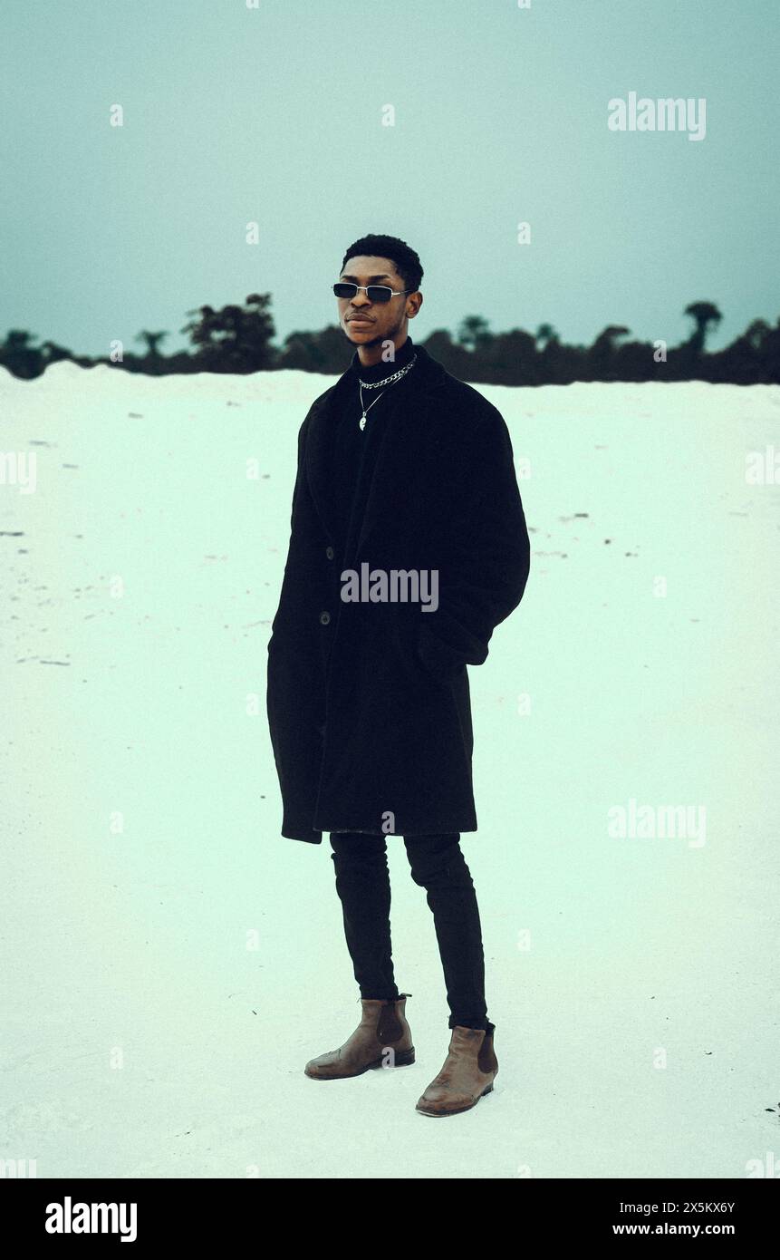 Nigeria, stato del Delta, Ritratto di un uomo elegante in piedi sulla sabbia Foto Stock