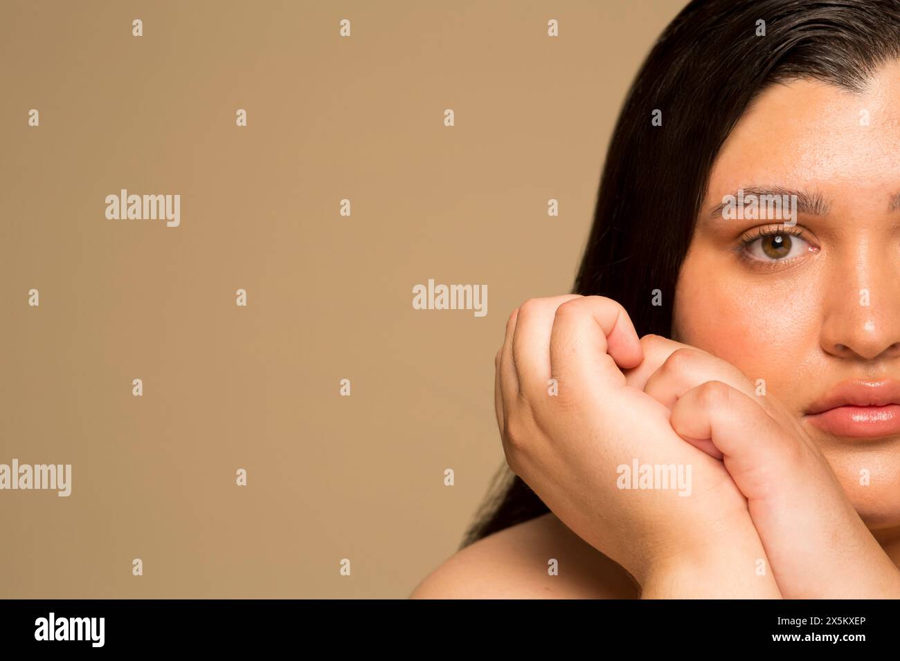Primo piano di una giovane donna con le mani strette Foto Stock
