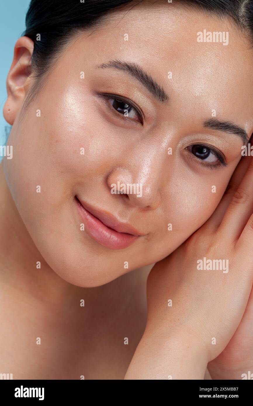 Primo piano di una donna sorridente con le mani strette Foto Stock