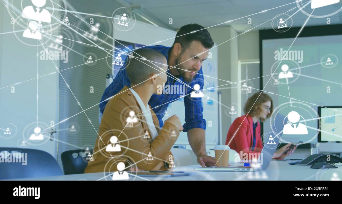 Immagine di icone connesse su diversi colleghi che discutono della progettazione di un prodotto su un notebook in ufficio Foto Stock