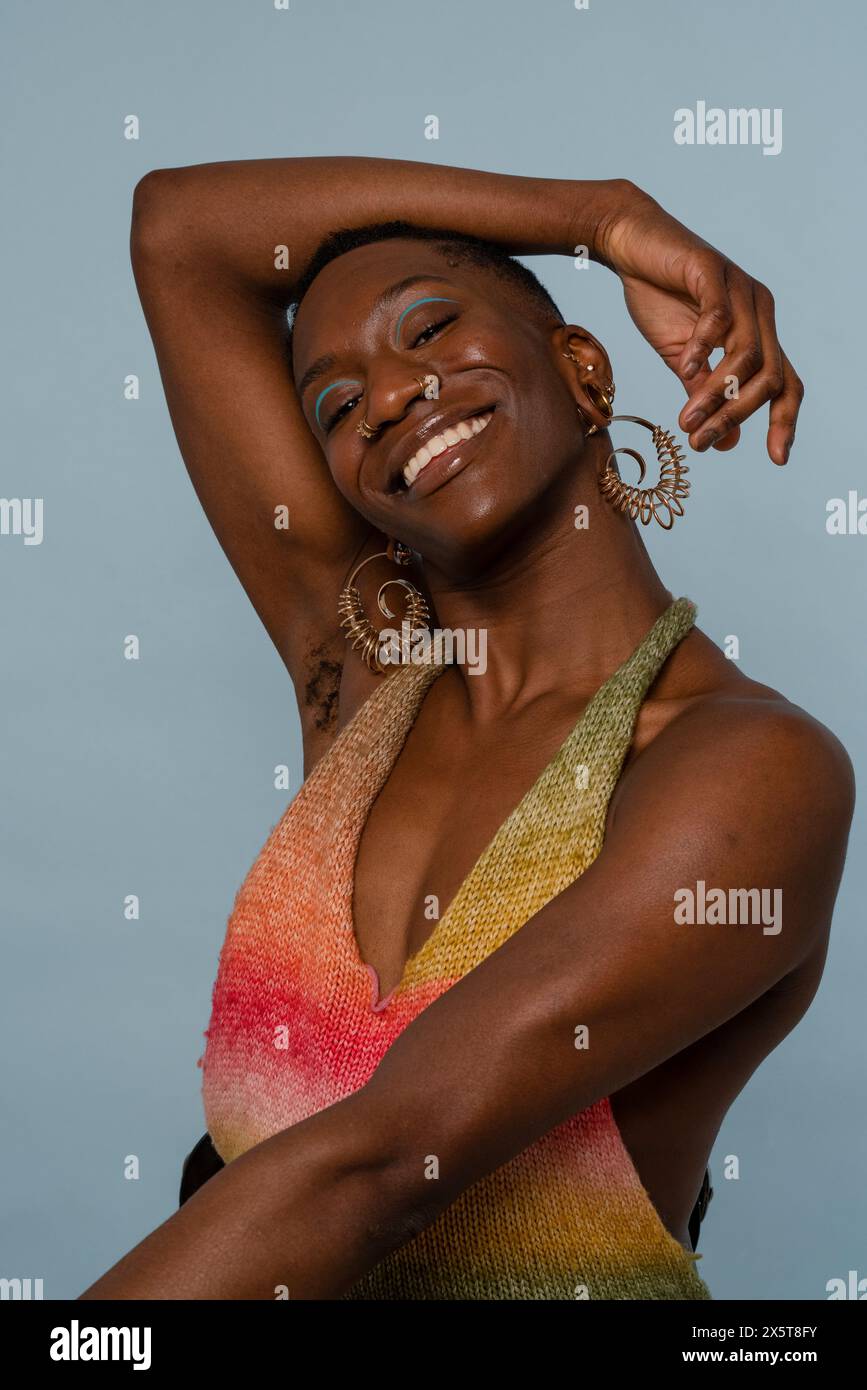 Giovane donna sorridente in top colorato Foto Stock