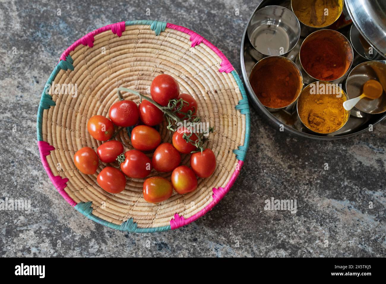 Pomodori ciliegini e spezie secche sul bancone della cucina Foto Stock