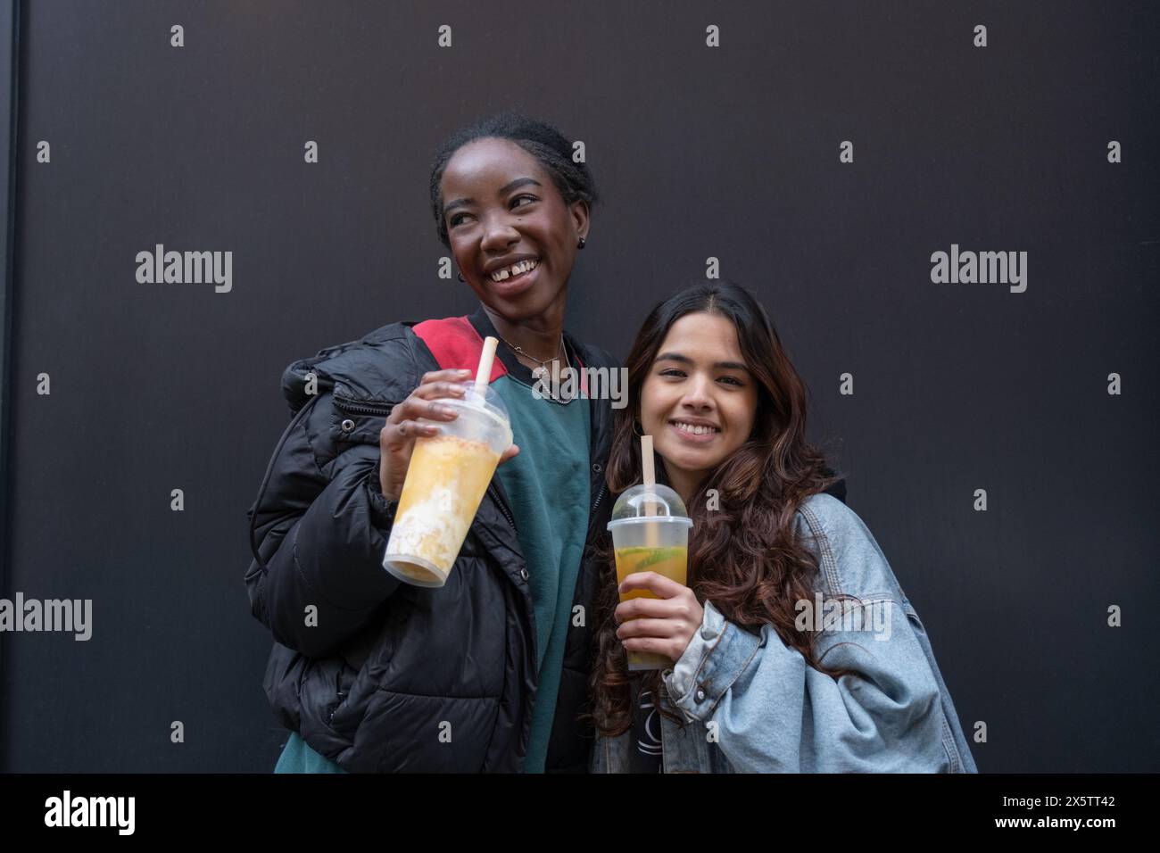 Ritratto di due donne allegre che bevono il tè bollicine Foto Stock