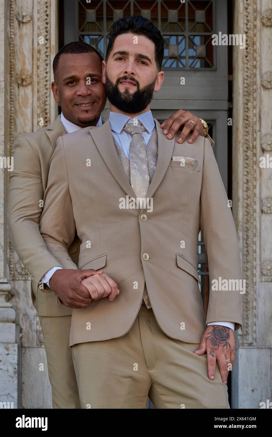 Ritratto di una coppia gay che celebra il loro amore, sono sposi novelli. Uno degli sposi ha un anello al dito che mostra il loro amore. Diversità Foto Stock