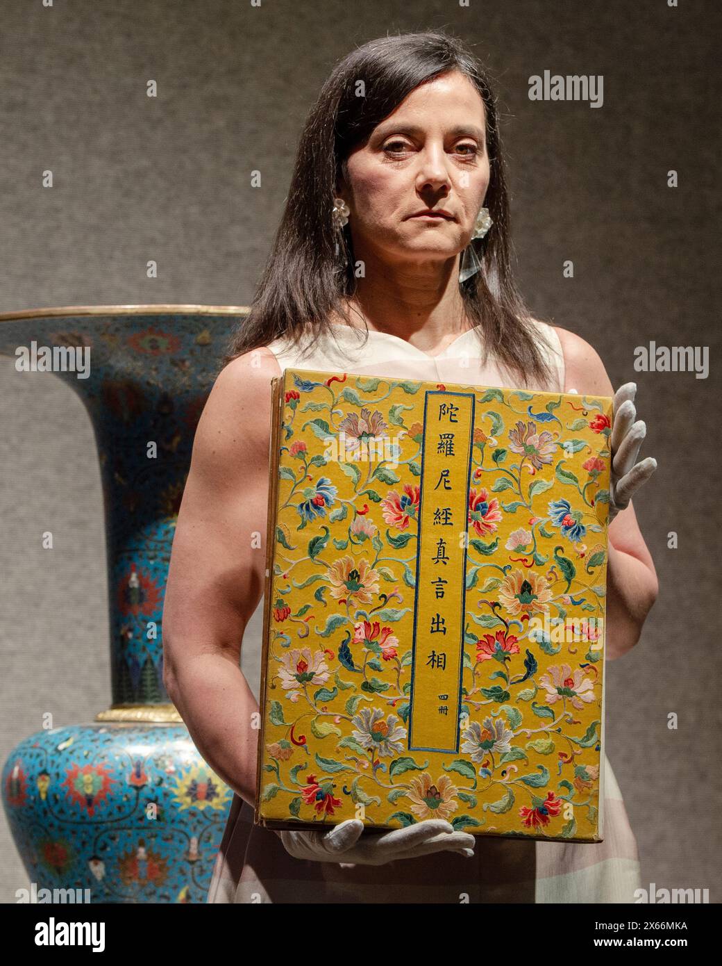 Londra, Inghilterra, Regno Unito. 13 maggio 2024. Il membro dello staff della Bonhams detiene un album dipinto imperiale del Daharani Sutra del XIX secolo, con un valore stimato di Â£40.000 - Â£60.000, durante una chiamata fotografica a Bonhams Londra. (Credit Image: © Thomas Krych/ZUMA Press Wire) SOLO PER USO EDITORIALE! Non per USO commerciale! Crediti: ZUMA Press, Inc./Alamy Live News Foto Stock