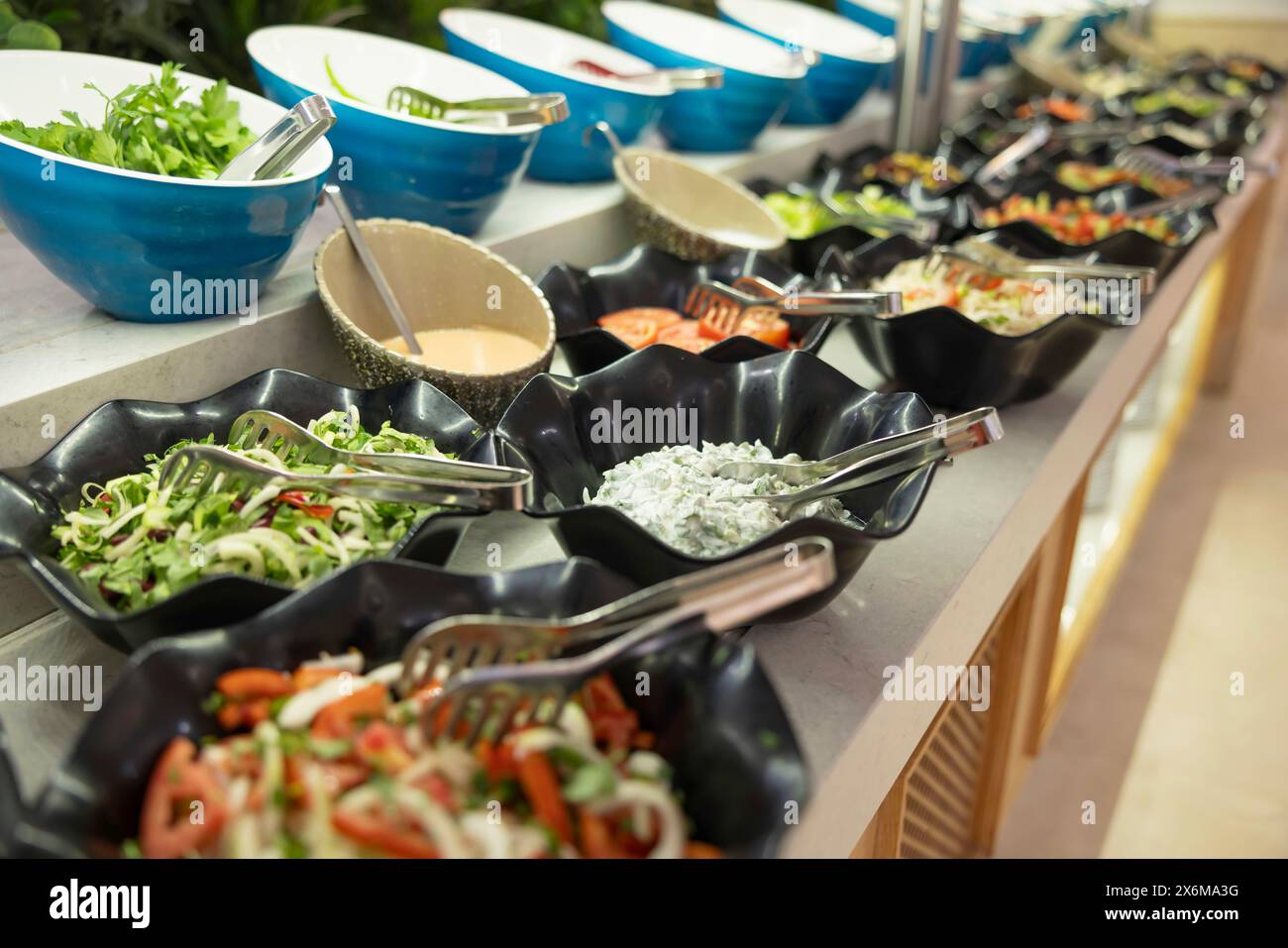 Insalate e verdure fresche in ciotole sul tavolo a buffet dell'hotel Foto Stock