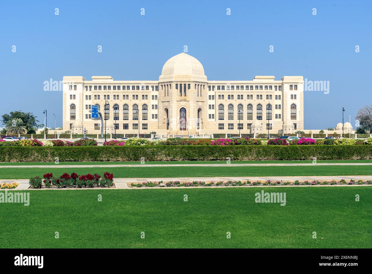 Mascate, Oman - 2 gennaio 2024: Un capolavoro di architettura moderna, si crogiola nel luminoso sole dell'Oman tra lussureggianti giardini verdi. Foto Stock