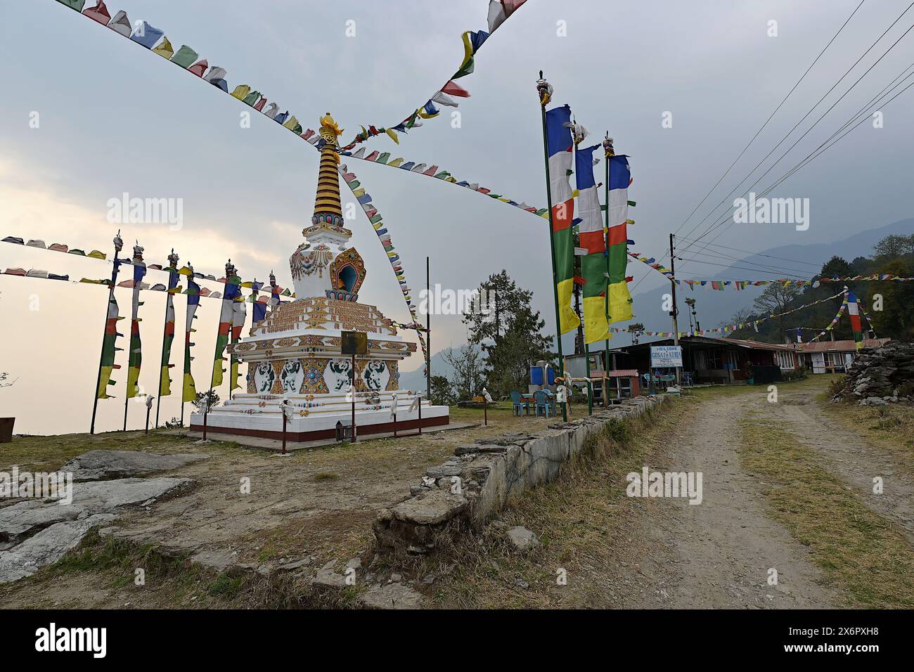 Kutumsang, Nepal - 17 aprile 2024: Un corten buddista tibetano o stupa e bandiere di preghiere, nel villaggio Tamang lungo l'Helambu Trek Foto Stock