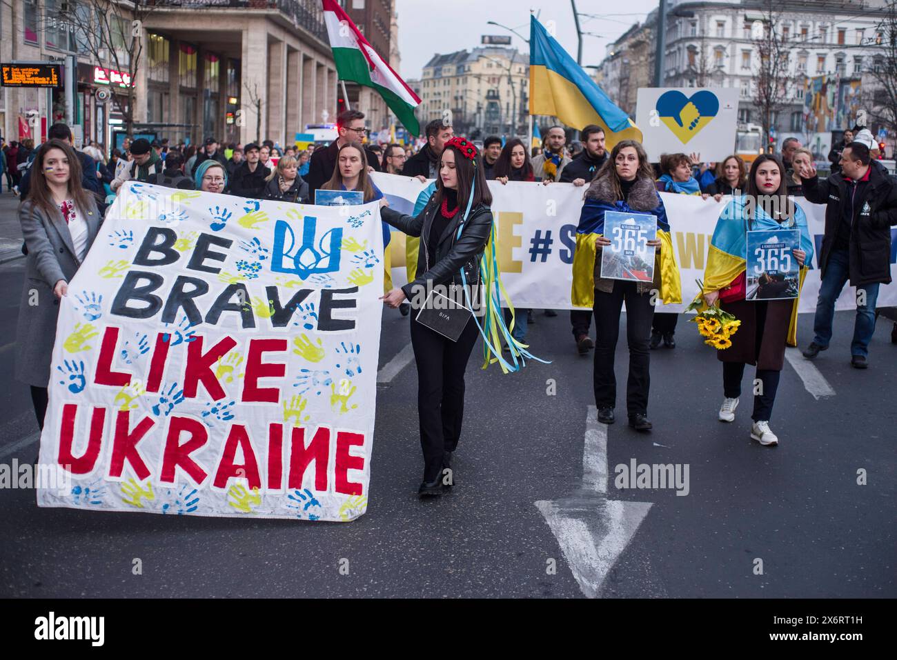 Dimostrazione di solidarietà Ucraina, Budapest, Ungheria UNGARN, 24.02.2023, Budapest V. Bezirk. Ukrainekrieg: Solidartitaetsdemo zum 1. La Jahrestag des russischen ha totalizzato Angriffs. Zug verlaesst den Deak Platz. Banner sei so tapfer wie die Ucraina . Guerra in Ucraina: Dimostrazione di solidarietà per l'Ucraina in occasione del 1 ° anniversario dell'attacco russo su vasta scala. Marciando da piazza Deak. Striscione siate coraggiosi come l'Ucraina . Â *** manifestazione di solidarietà Ucraina, Budapest, Ungheria UNGHERIA, 24 02 2023, Budapest V distretto Ucraina guerra manifestazione di solidarietà in occasione del 1° anniversario della sca completa russa Foto Stock