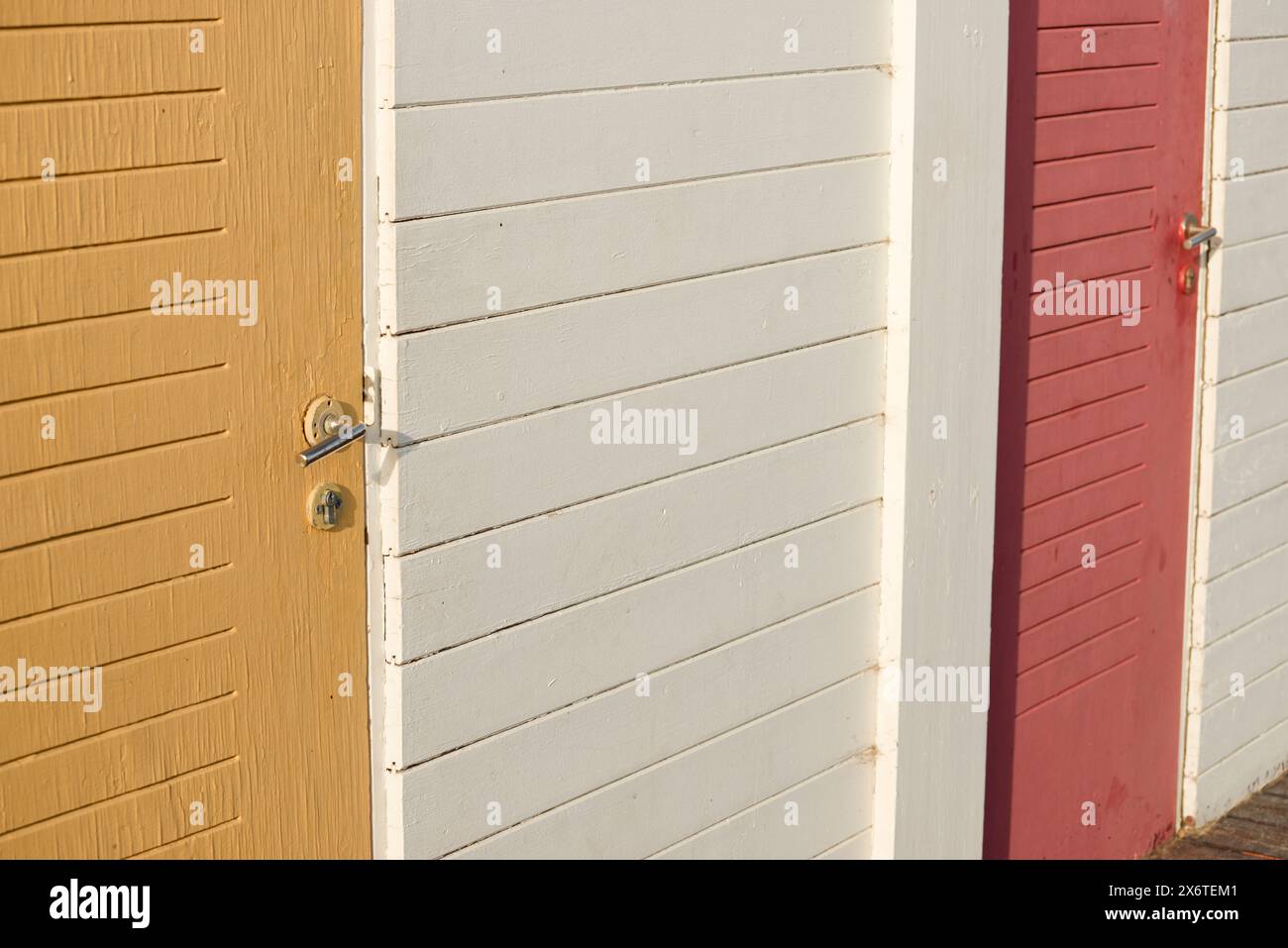Vecchie superfici in legno verniciato sbiadito. Porta e maniglia. Foto Stock