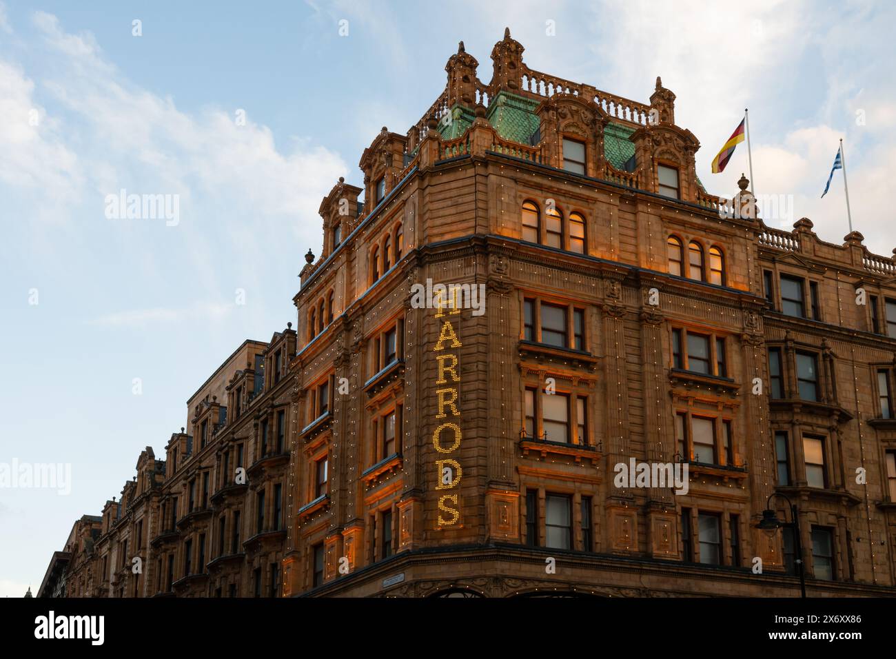 Londra, Regno Unito - 22 marzo 2024; dettaglio del cartello dei grandi magazzini Harrods illuminato sulla facciata con luce serale Foto Stock