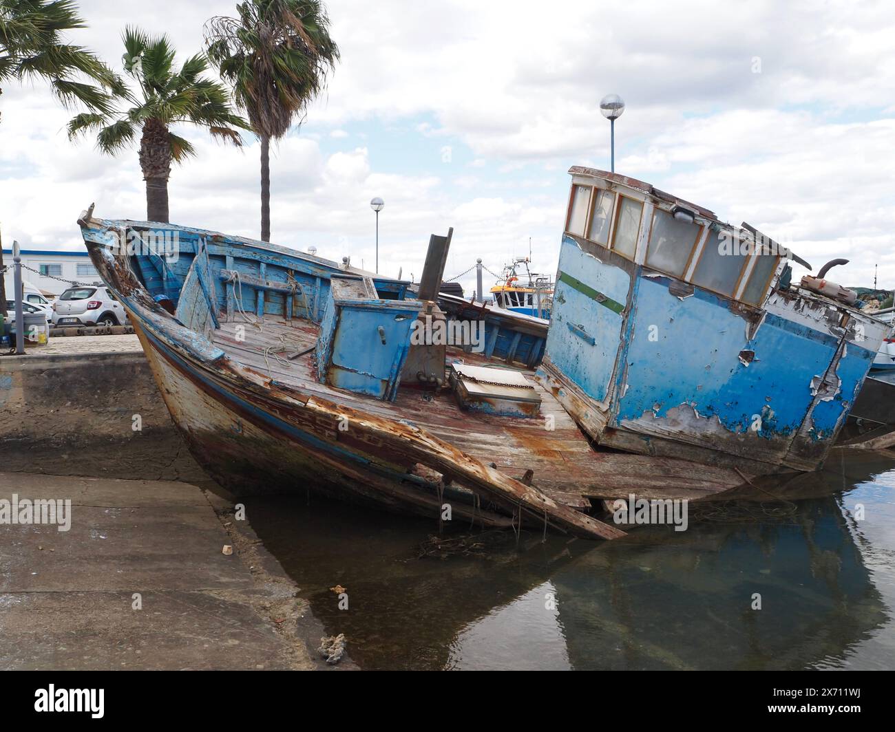 Barca abbandonata e parzialmente sommersa Joana e Joao nel porto turistico di Fuseta (Fuzeta) nell'Algarve in Portogallo Foto Stock