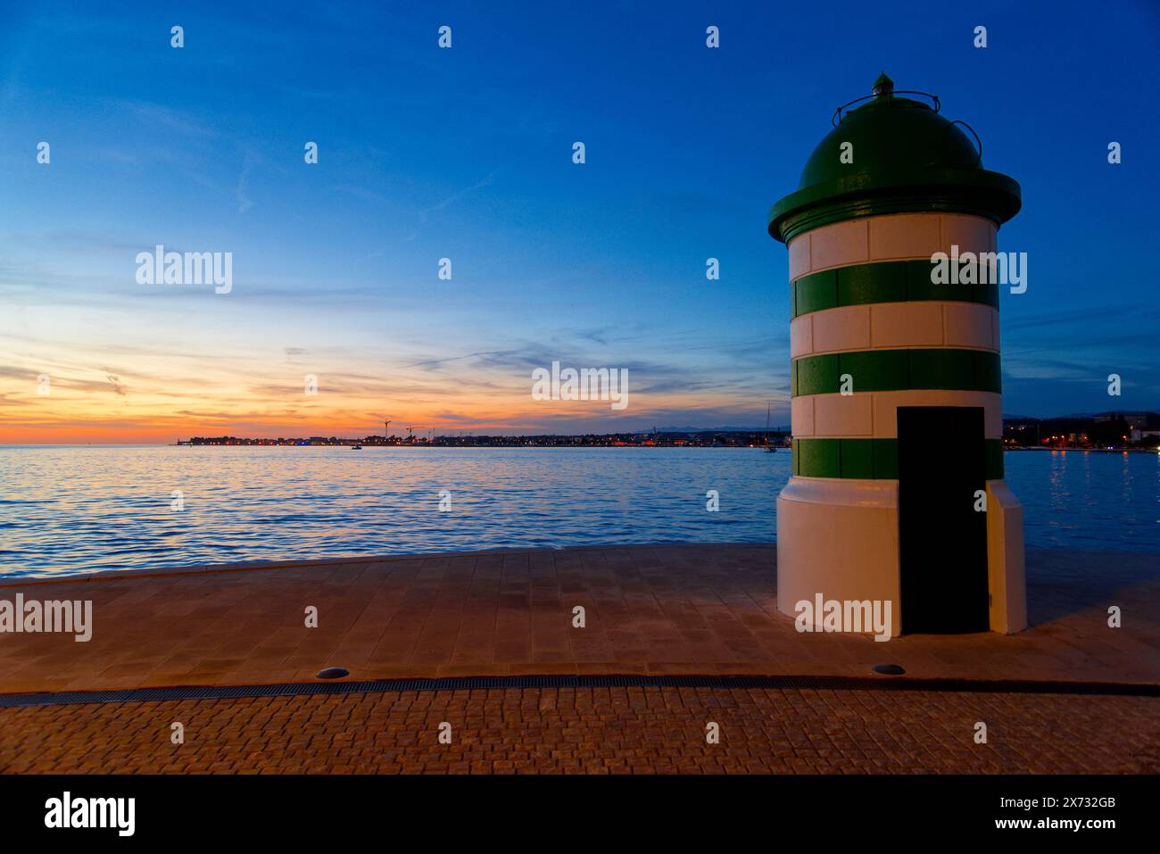 le phare à la sortie du port de Zadar en croatie au coucher du soleil Foto Stock