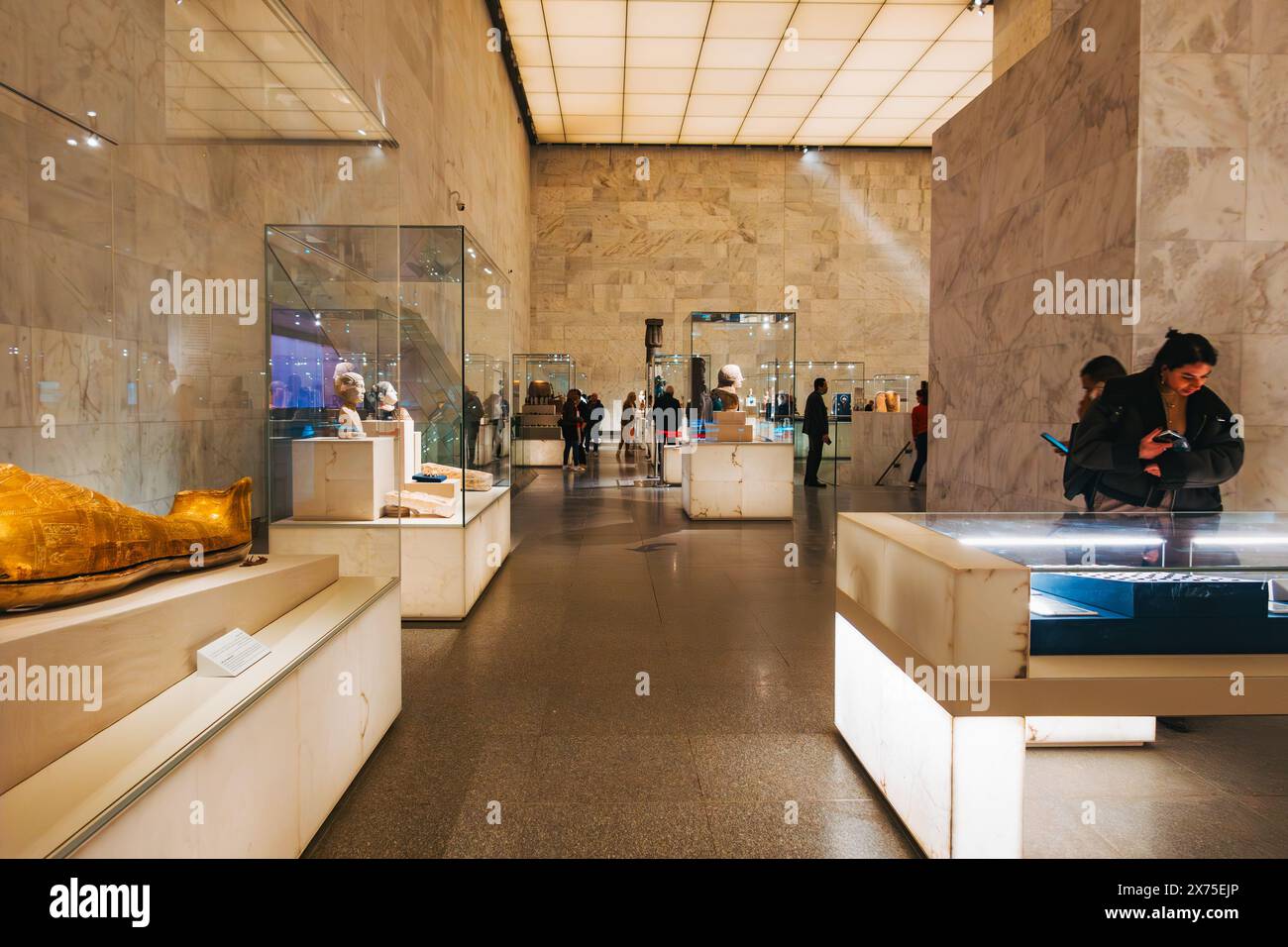 All'interno del Museo Nazionale della civiltà egizia del Cairo, con statue, mostre e visitatori sotto un soffitto a griglia illuminato dal cielo Foto Stock
