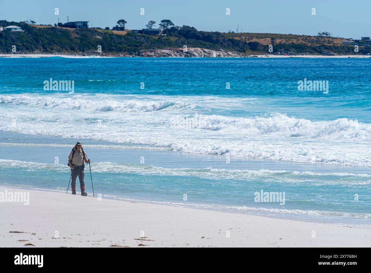 Escursionista solitario che cammina sulla spiaggia di sabbia bianca, Swimcart Beach, Bay of Fires, Tasmania Foto Stock