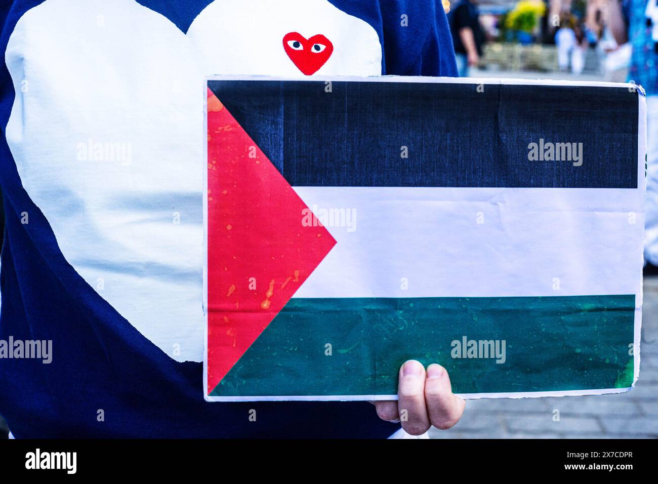 18 maggio 2024, Varsavia, Mazovia, Polonia: Un manifestante tiene un cartello con la bandiera palestinese mentre indossa una felpa a cuore d'amore durante la manifestazione. I manifestanti pro-palestinesi tengono una dimostrazione di morte in Piazza del Castello di Varsavia. In commemorazione della Nakba a partire dal 1948, i manifestanti sono rimasti immobile sul terreno. In seguito un certo numero di palestinesi e polacchi-palestinesi raccontarono le loro storie al pubblico riunito. (Credit Image: © Neil Milton/SOPA Images via ZUMA Press Wire) SOLO PER USO EDITORIALE! Non per USO commerciale! Foto Stock