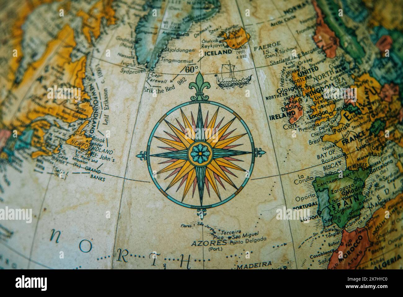 Primo piano di un globo d'epoca che mostra l'Europa e il Nord Atlantico con una dettagliata rosa di bussola. Foto Stock