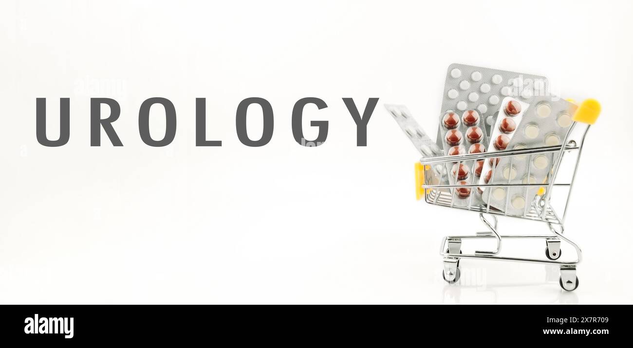 Un carrello pieno di medicine per il sistema urinario. Il carrello è argento e ha un manico giallo Foto Stock