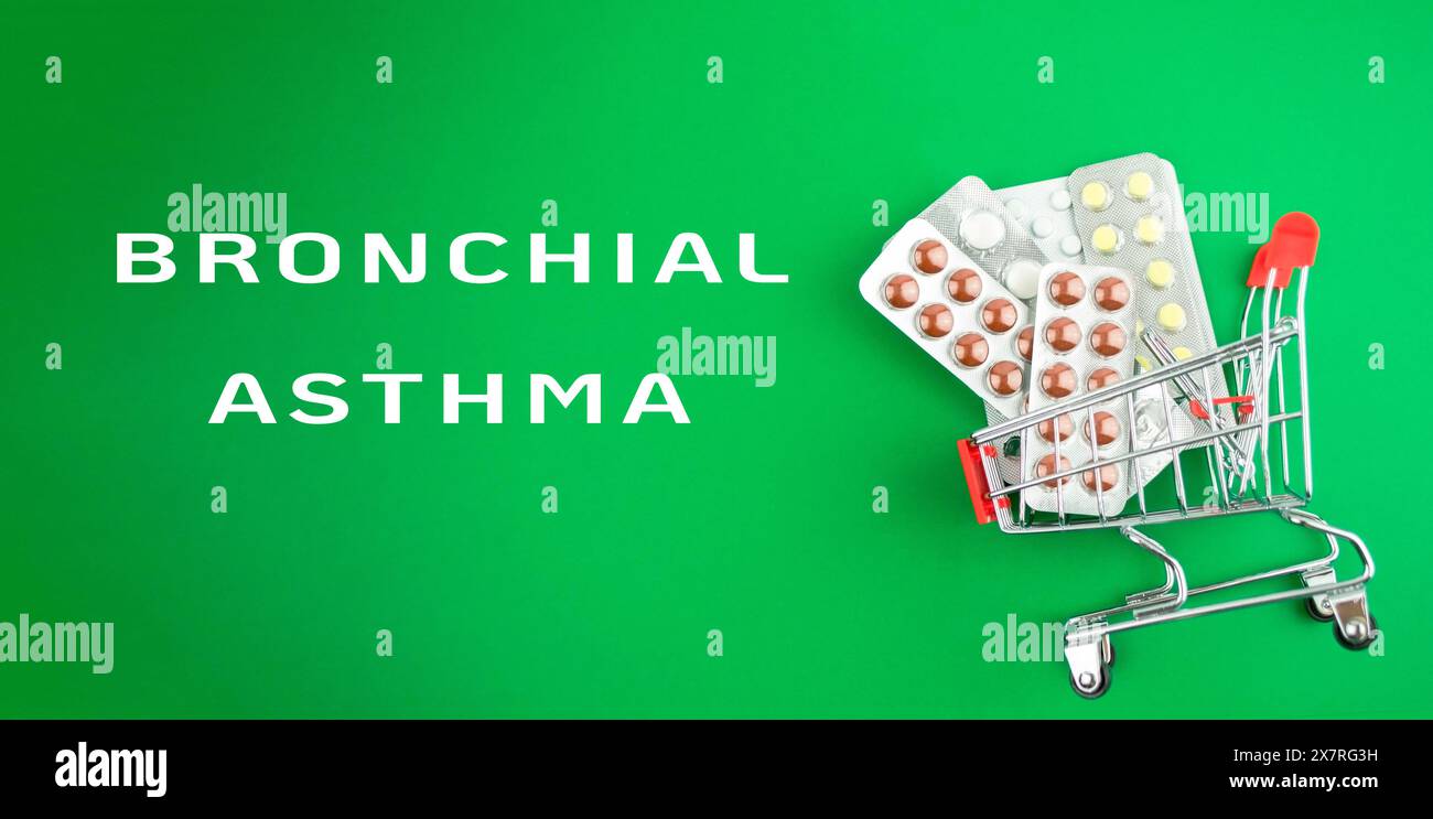 Un carrello pieno di medicine per l'asma bronchiale. Il carrello si trova su uno sfondo verde Foto Stock