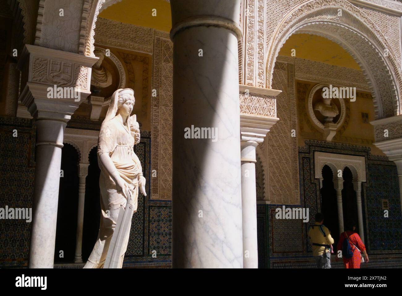 Due visitatori nel cortile del palazzo in stile mudejar del xvi secolo Casa de Pilatos a Siviglia, Andalusia, Spagna Foto Stock