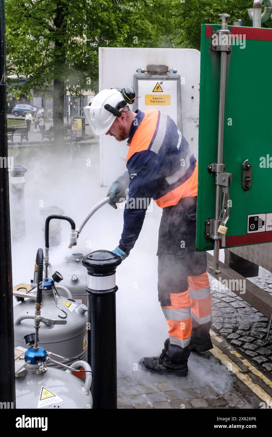 Operatore di prodotti ad aria che riempie le fiasche Dewar con azoto liquido a Bristol Foto Stock