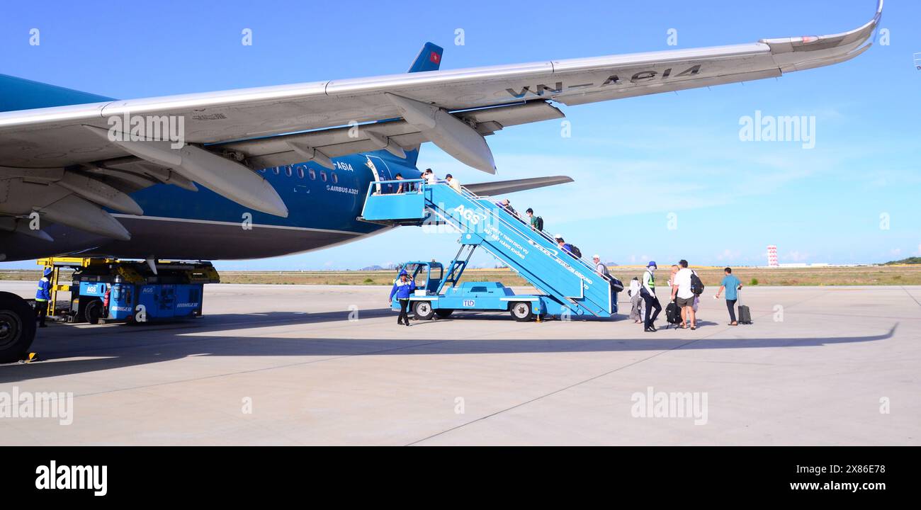 Imbarco dei passeggeri, tramite le scale di imbarco, un Airbus A321 Vietnam Airlines presso l'aeroporto internazionale Cam Ranh, IATA: CXR, vicino a Nha Trang, Vietnam Foto Stock