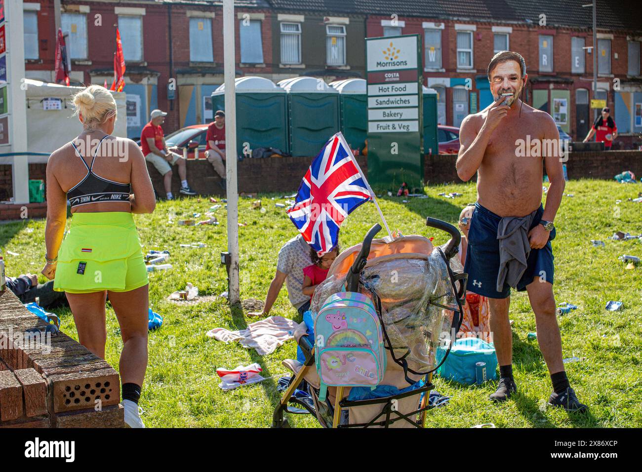 Famiglia con bandiera unionista nella zona svantaggiata di Anfield Liverpool Merseyside Inghilterra . Foto Stock