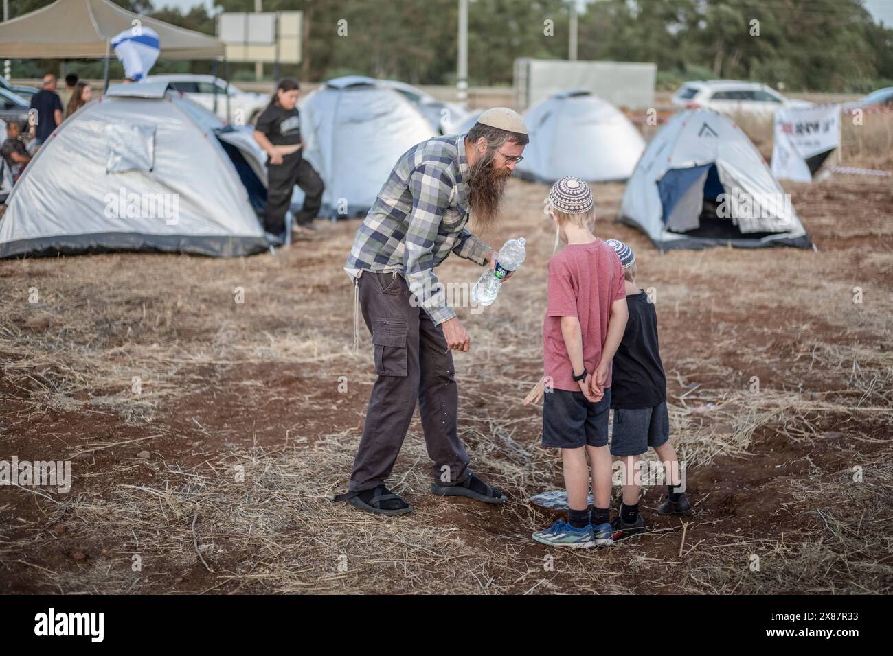 23 maggio 2024, Israele, Kibbutz ami'ad: Israeliani evacuati dalle aree settentrionali vicino al confine libanese a causa delle continue tensioni transfrontaliere, si trovano tra le tende durante una manifestazione che chiama il governo per farli tornare a casa. Foto: Ilia Yefimovich/dpa Foto Stock