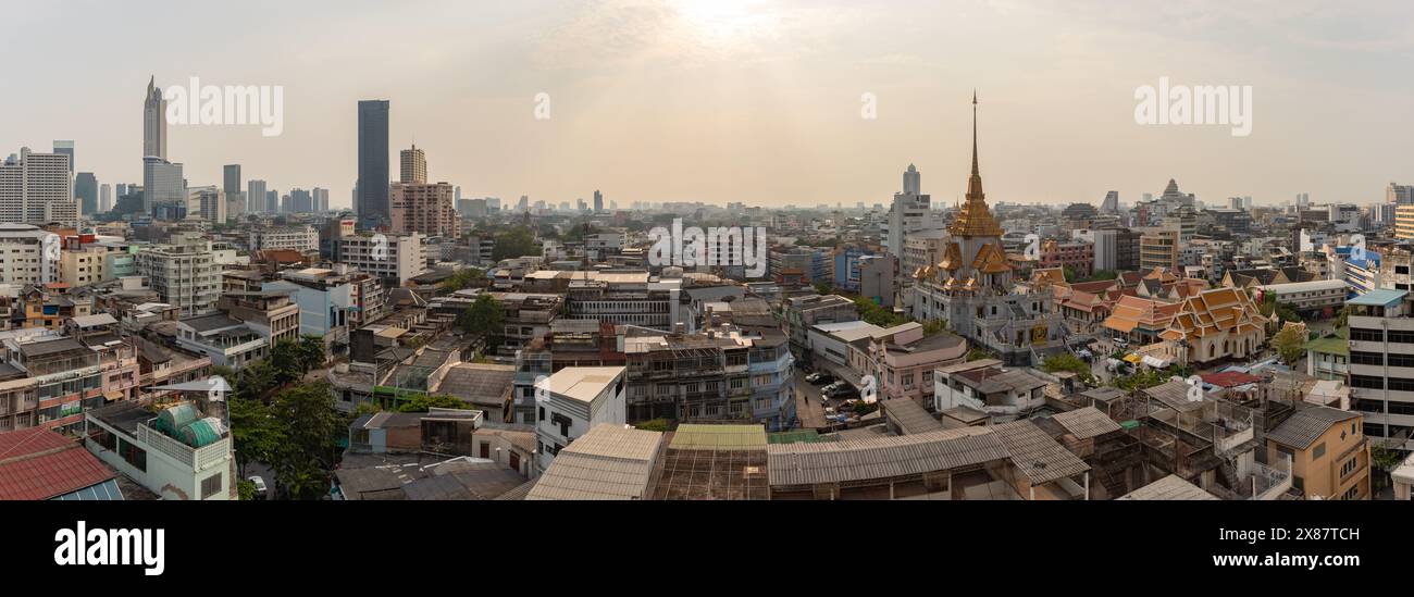 Una foto panoramica dei tetti dei quartieri Samphanthawong, Bang Rak e Khlong San di Bangkok, con il Tempio Wat Traimit Withayaram Worawihan Foto Stock