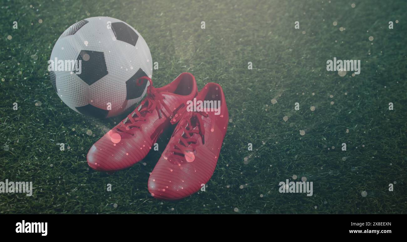 Immagine di spot luminosi su scarpe sportive e calcio Foto Stock