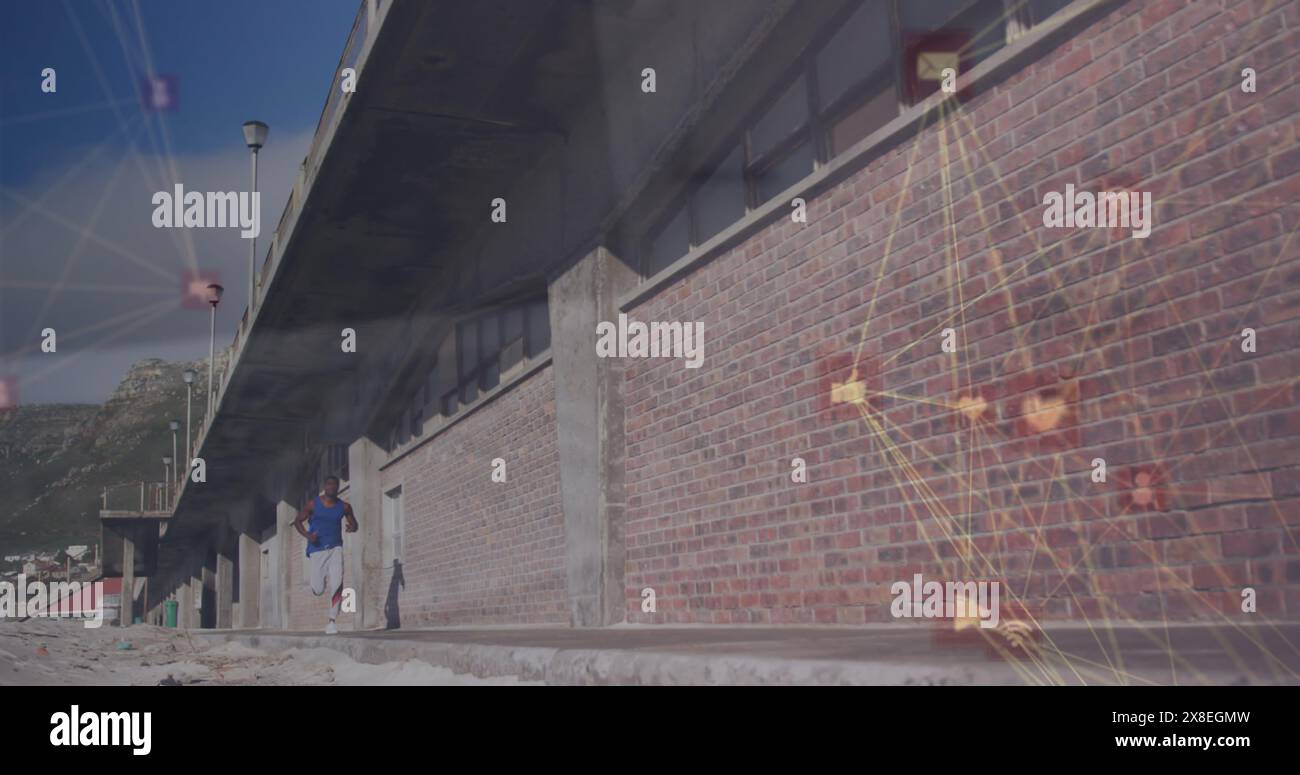 Immagine di icone collegate globo sopra l'uomo afroamericano che corre accanto al muro di mattoni Foto Stock