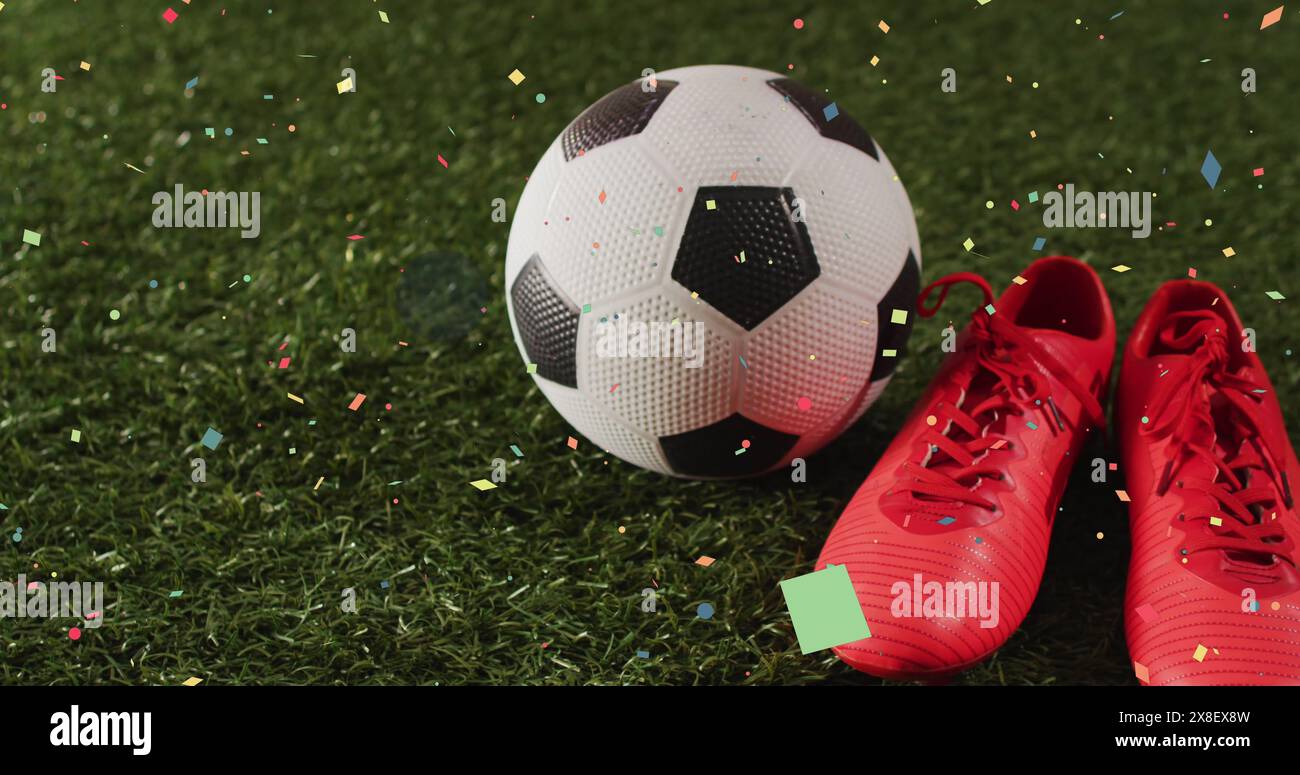 Immagine di coriandoli che cadono sopra le scarpe sportive e il calcio Foto Stock