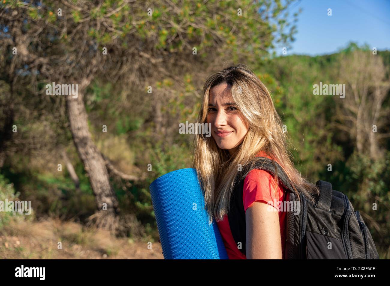 Ritratto di donna con tappetino per lo sport in natura Foto Stock
