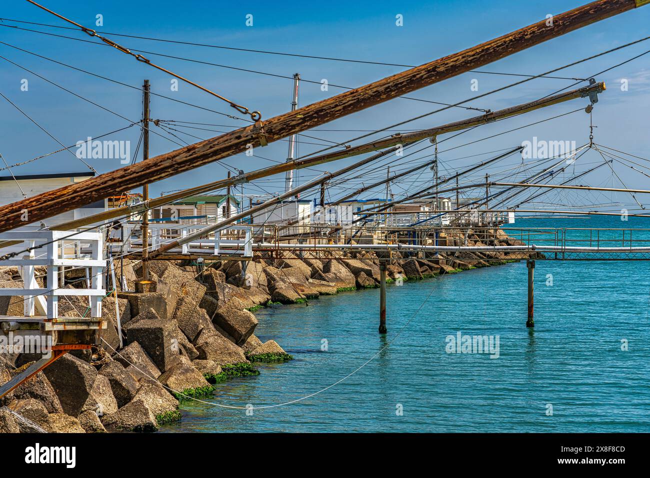 Nel porto di Giulianova i "caliscendi", strutture in legno utilizzate per la piccola pesca che si tuffano dalle rocce verso il mare. Abruzzo Foto Stock