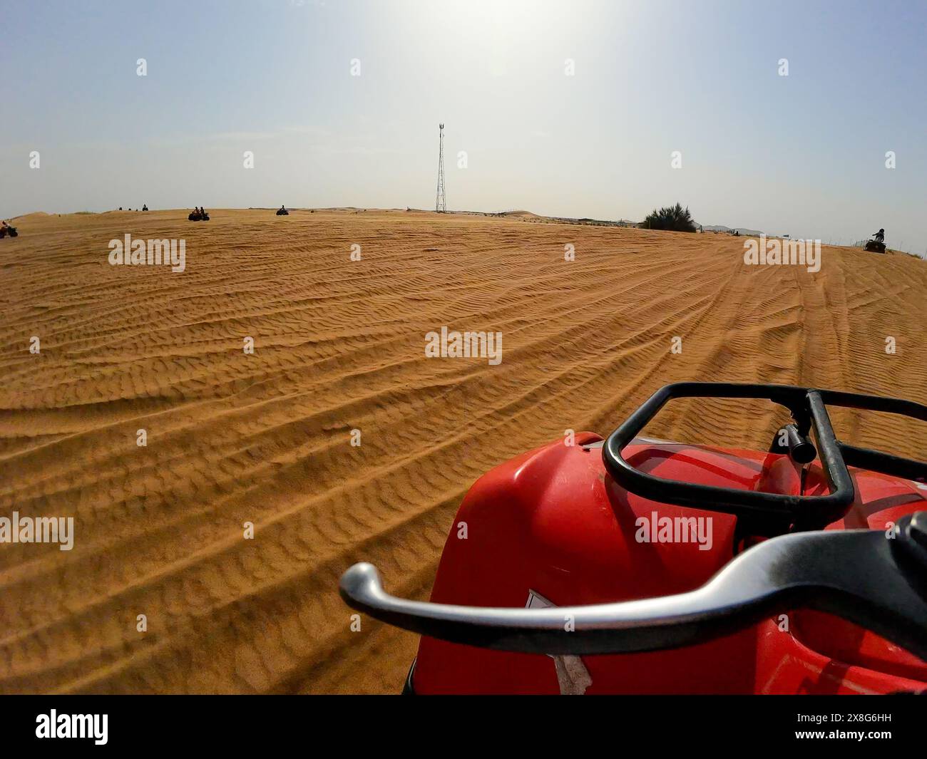 Fotografie di ATV che guidano attraverso il deserto rosso negli Emirati Arabi Uniti vicino a Dubai durante il giorno di sole primaverile Foto Stock