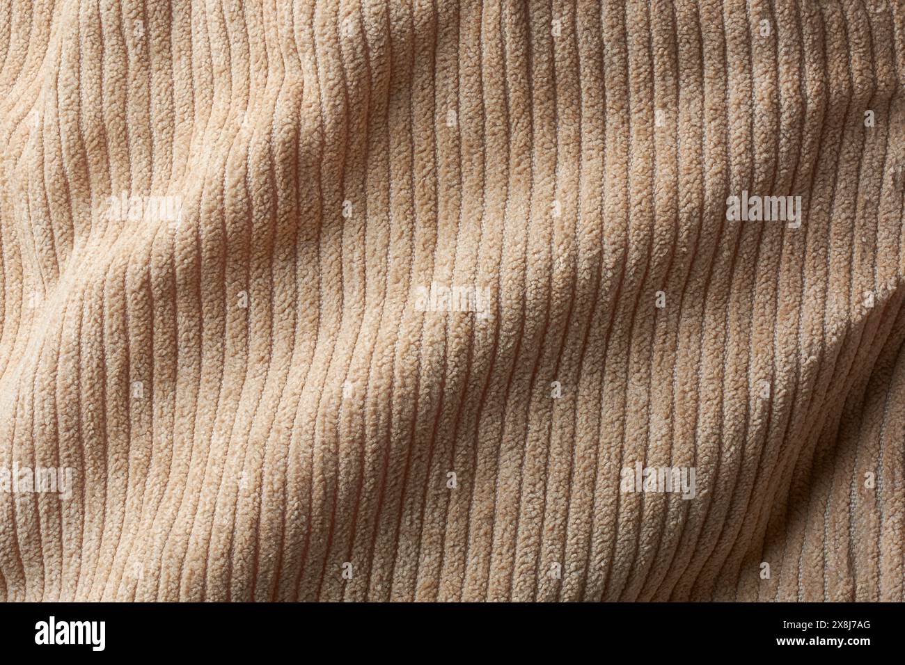 superficie in morbido tessuto vellutato marrone chiaro superficie di sfondo, materiale di cotone astratto per pantaloni, giacche, gonne con uno stile accattivante Foto Stock