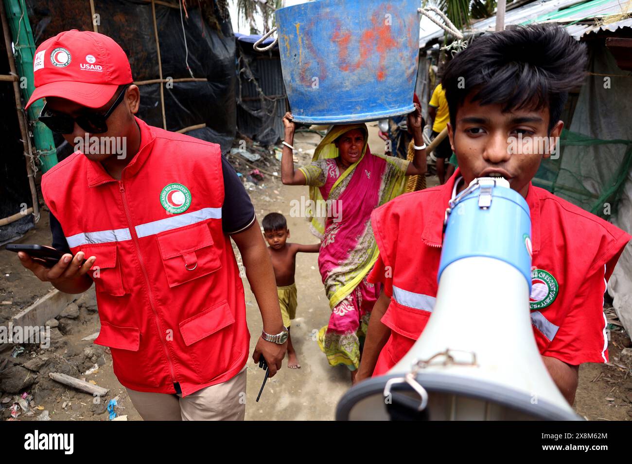 Chittagong, Halishahar, Bangladesh. 26 maggio 2024. I volontari della Mezzaluna Rossa sollecitano i residenti del vulnerabile villaggio di pescatori di Chittagong Halisahar Sagar Par ad evacuare prima di Cyclone Remal. Il Bangladesh Meteorological Department ha emesso il segnale di soccorso numero 10 (dieci) ai porti marittimi di Payra e Mongla e il segnale di soccorso numero 09 (nove) ai porti marittimi di Cox's Bazar e Chittagong. (Credit Image: © Mohammed Shajahan/ZUMA Press Wire) SOLO PER USO EDITORIALE! Non per USO commerciale! Crediti: ZUMA Press, Inc./Alamy Live News Foto Stock