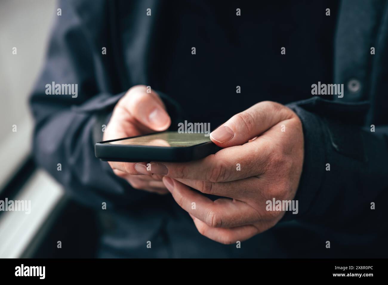 Donna che digita un messaggio di testo sul telefono cellulare mentre viaggia su un autobus dei trasporti pubblici, attenzione selettiva Foto Stock