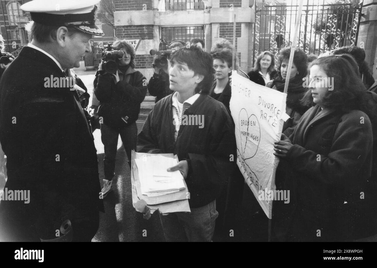 ALISON HOWELL PRESENTA UNA PETIZIONE AL COMMODORO CHRIS HEBRON DELLA HMS NELSON COME PROTESTA DELLE MOGLI DELLA MARINA A PORTSMOUTH PER I PIANI DI CONSENTIRE ALLE WRENS DI SERVIRE A BORDO DELLE NAVI IN MARE, 1990 PIC MIKE WALKER, 1990 Foto Stock