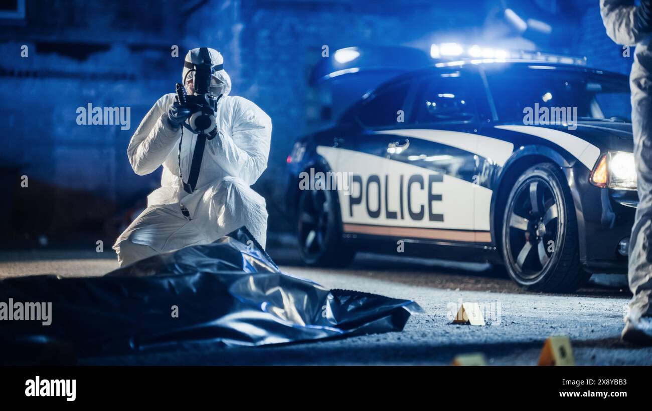 Esperto forense che scatta foto del cadavere della vittima in una borsa per il corpo in una scena del crimine. Dipartimento di polizia sul posto, raccolta di indizi e registrazione di prove per aprire un fascicolo e prendere il colpevole Foto Stock