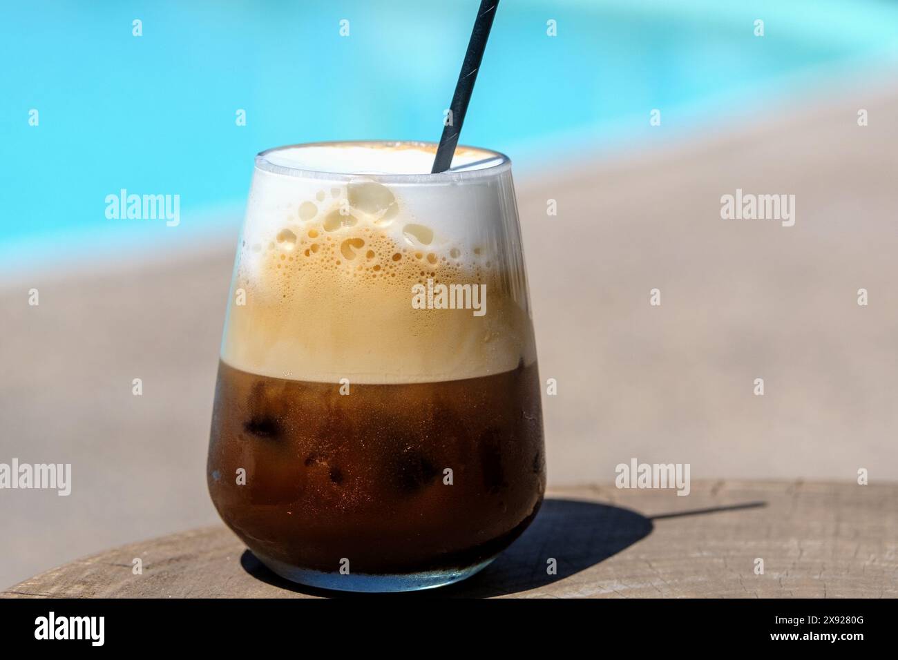 Vista da vicino di un caffè greco ghiacciato, noto anche come cappuccino freddo con una paglia in Grecia iOS Foto Stock