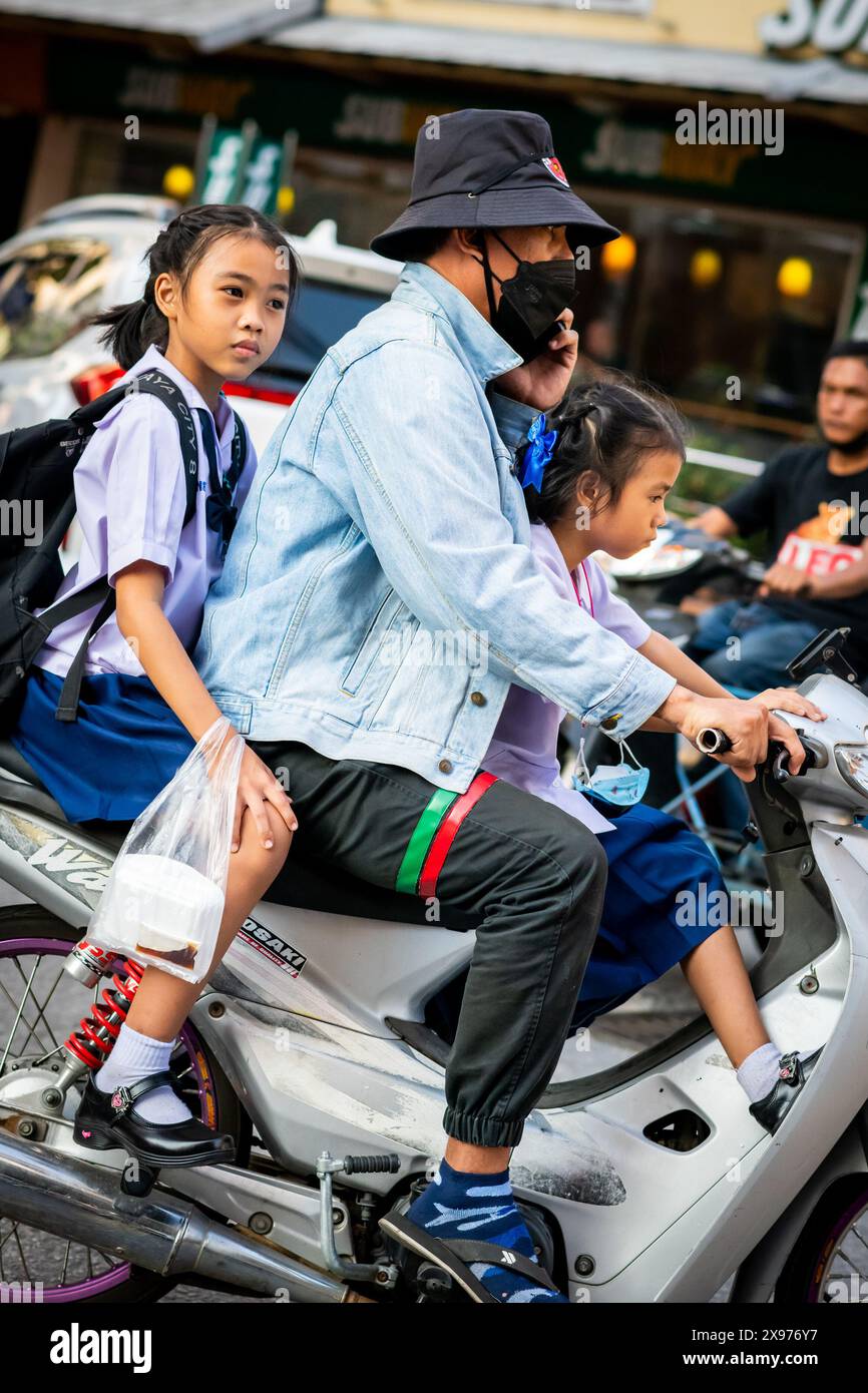 Due bellissime studentesse thailandesi tornano a casa su uno scooter a Pattaya in Thailandia. Viaggiando lungo Soi Buakhao nel centro di Pattaya. Foto Stock