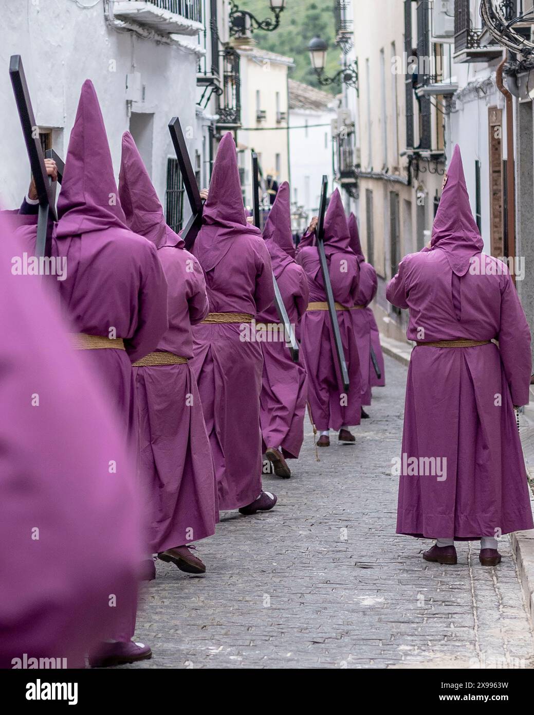 Fede nelle Ombre: Il viaggio enigmatico dei partecipanti incappucciati Foto Stock