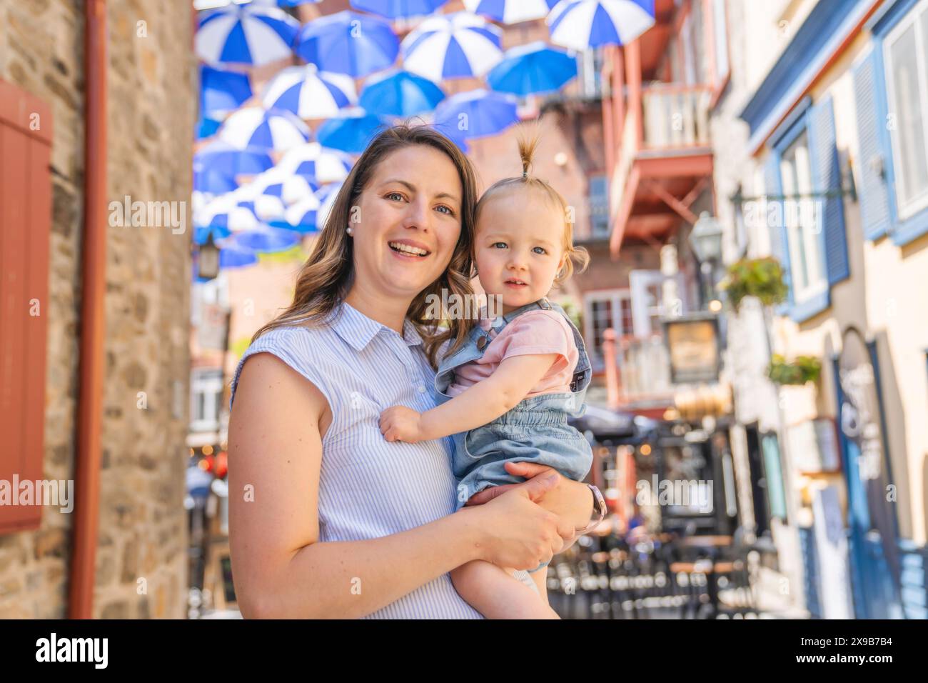 Madre giovane in strada con bambina piccola Foto Stock