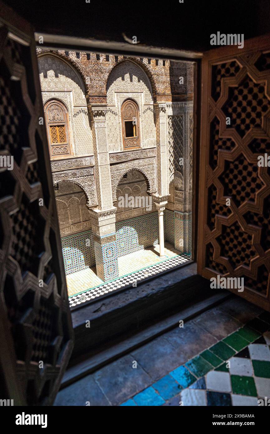Cortile al Attarine Madrassa, finestre ai piani superiori a Fez, Marocco Foto Stock